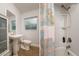 Well-lit bathroom with a pedestal sink, frosted window and shower-tub combo at 1403 W Pradera Ave, Tampa, FL 33612