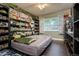 Unique bedroom with dinosaur decor, filled shelves, and a comfortable bed, creating a distinctive space at 1403 W Pradera Ave, Tampa, FL 33612