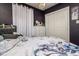This bedroom features a large bed, closet, and a white dresser against a dark gray wall at 1403 W Pradera Ave, Tampa, FL 33612