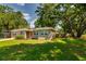 Lovely home with lush lawn, mature trees, and a cozy entrance with meticulously trimmed bushes at 1403 W Pradera Ave, Tampa, FL 33612