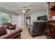 Inviting living room with neutral colors, tile flooring, and an open layout flowing into the kitchen at 1403 W Pradera Ave, Tampa, FL 33612