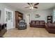 Comfortable living room features tile floors, neutral paint, ceiling fan, and classic furnishings at 1403 W Pradera Ave, Tampa, FL 33612