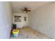 Enclosed porch with a ceiling fan, door, and window overlooking the yard at 1403 W Pradera Ave, Tampa, FL 33612