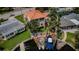 Aerial view of a waterfront home with a private dock, a beautiful yard, and a terracotta colored roof at 1427 40Th Ne Ave, St Petersburg, FL 33703