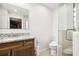 Bathroom features a modern vanity with a granite countertop, toilet, and glass-enclosed shower at 1427 40Th Ne Ave, St Petersburg, FL 33703