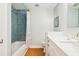 Bright bathroom with blue herringbone tiled shower and white vanity at 1427 40Th Ne Ave, St Petersburg, FL 33703