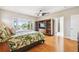 Bright bedroom with balcony access, tropical bedding, and wooden floors at 1427 40Th Ne Ave, St Petersburg, FL 33703