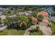 Beautiful home with mature landscaping, a circular driveway, and a terracotta colored roof in a waterfront community at 1427 40Th Ne Ave, St Petersburg, FL 33703