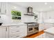 Gourmet kitchen featuring stainless steel appliances, including a professional-grade range and custom cabinetry at 1427 40Th Ne Ave, St Petersburg, FL 33703