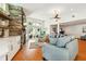 Spacious living room features a stone fireplace, hardwood floors, and lots of natural light and open concept design at 1427 40Th Ne Ave, St Petersburg, FL 33703