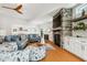 Inviting living room with stone fireplace, wood floors, and open layout with seamless kitchen access at 1427 40Th Ne Ave, St Petersburg, FL 33703