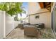 Cozy outdoor seating area with travertine tile, wicker furniture, and lush tropical landscaping at 1427 40Th Ne Ave, St Petersburg, FL 33703