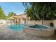 Gorgeous pool and jacuzzi, surrounded by lush tropical landscaping, a covered patio, and travertine tile at 1427 40Th Ne Ave, St Petersburg, FL 33703
