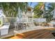 Relaxing waterfront patio with outdoor seating and lush tropical landscaping overlooking the water at 1427 40Th Ne Ave, St Petersburg, FL 33703