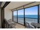 Enjoy stunning ocean views from the balcony with seating arrangements, ideal for morning coffee at 14950 Gulf Blvd # 905, Madeira Beach, FL 33708