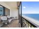 Balcony with chairs offering a beautiful ocean view and beach access at 14950 Gulf Blvd # 905, Madeira Beach, FL 33708