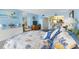 Bedroom view featuring bright light blue walls, furniture, a kitchen view, and nautical décor at 14950 Gulf Blvd # 905, Madeira Beach, FL 33708