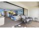 Cozy condo bedroom with balcony access, partial kitchen view, and comfortable seating at 14950 Gulf Blvd # 905, Madeira Beach, FL 33708