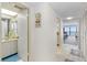 This hallway features tile flooring, a bathroom, and opens up to the living area with ocean views at 14950 Gulf Blvd # 905, Madeira Beach, FL 33708