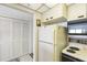 The kitchen includes white appliances and cabinets, a pantry, and a microwave at 14950 Gulf Blvd # 905, Madeira Beach, FL 33708