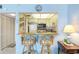 Kitchen view with a breakfast bar and seating. Appliances are white at 14950 Gulf Blvd # 905, Madeira Beach, FL 33708