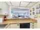 Galley kitchen with breakfast bar, view of dining, living and Gulf at 14950 Gulf Blvd # 905, Madeira Beach, FL 33708