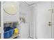 The laundry room includes a washer, dryer, shelving, and a door with a lock at 14950 Gulf Blvd # 905, Madeira Beach, FL 33708