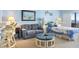 This living area features an ocean view, a sleeper sofa, chairs, and a bed at 14950 Gulf Blvd # 905, Madeira Beach, FL 33708
