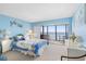 Bright bedroom featuring access to a balcony with ocean views, creating a tranquil living space at 14950 Gulf Blvd # 905, Madeira Beach, FL 33708