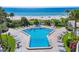 Resort pool with tropical landscaping, beach views, and sun loungers at 14950 Gulf Blvd # 905, Madeira Beach, FL 33708