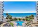 Resort pool with tropical landscaping, beach views, and sun loungers at 14950 Gulf Blvd # 905, Madeira Beach, FL 33708