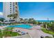 Resort pool with tropical landscaping, tiki bar, and beach views at 14950 Gulf Blvd # 905, Madeira Beach, FL 33708