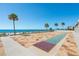 Resort shuffleboard court with palm trees, pool, beach and ocean views at 14950 Gulf Blvd # 905, Madeira Beach, FL 33708