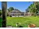 Expansive backyard featuring a brick home, manicured lawn, and patio at 16502 Millan De Avila, Tampa, FL 33613