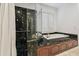 Well-lit bath with marble details, shower and tub at 16502 Millan De Avila, Tampa, FL 33613