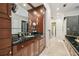 Bathroom features black and green marble countertops, dark wood cabinets and a view to the exterior at 16502 Millan De Avila, Tampa, FL 33613