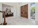 Elegant foyer with marble floors, grand double doors, and a view into the dining room at 16502 Millan De Avila, Tampa, FL 33613