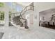 Grand foyer featuring a curved staircase, marble floors, and abundant natural light at 16502 Millan De Avila, Tampa, FL 33613