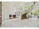 Grand foyer features a winding staircase, marble floors, and an abundance of natural light, creating an impressive entrance at 16502 Millan De Avila, Tampa, FL 33613