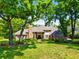 Stately brick home with mature trees, lush landscaping, and a well-manicured lawn at 16502 Millan De Avila, Tampa, FL 33613
