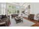 Sophisticated living room with soaring ceilings, large windows, and stylish leather seating at 16502 Millan De Avila, Tampa, FL 33613