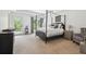 Spacious primary bedroom with a four-poster bed, tray ceilings, and outdoor access at 16502 Millan De Avila, Tampa, FL 33613