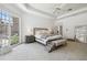 Light-filled main bedroom features tray ceiling, neutral color palette, and an exterior view at 16502 Millan De Avila, Tampa, FL 33613