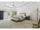Spacious main bedroom with tray ceilings, large window, and french doors to the exterior at 16502 Millan De Avila, Tampa, FL 33613