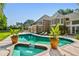 Beautiful backyard pool and spa area with brick accents and mature landscaping at 16502 Millan De Avila, Tampa, FL 33613