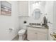Stylish powder room with granite countertop, decorative mirror, and modern fixtures at 16502 Millan De Avila, Tampa, FL 33613