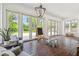 Brick floored sunroom with beadboard ceiling and wall of windows has views of the landscaped yard at 16502 Millan De Avila, Tampa, FL 33613
