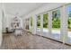 Large sunroom has brick floors, beadboard ceilings, views to the landscaped backyard through a wall of windows at 16502 Millan De Avila, Tampa, FL 33613