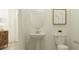 Stylish half bathroom with pedestal sink, toilet, and modern wall art at 16962 Warm Hand Ct, Land O Lakes, FL 34638