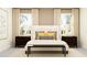Serene bedroom with a plush bed, matching nightstands, and windows that provide soft, natural light at 16962 Warm Hand Ct, Land O Lakes, FL 34638
